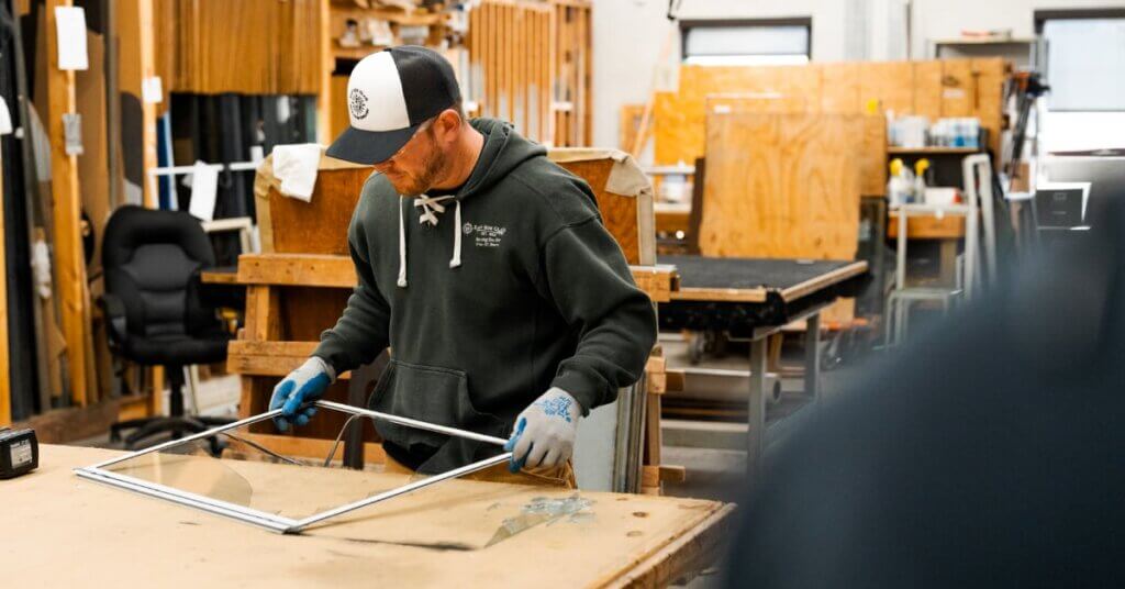 employee fixing a glass pane